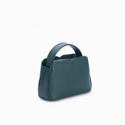 Handbag Loop Soleah em couro verde: bolsa de mão em couro de formato compacto, com alça superior curta e acabamento de linhas orgânicas; vista lateral em três quartos, mostrando profundidade, laterais, volume e construção da peça.